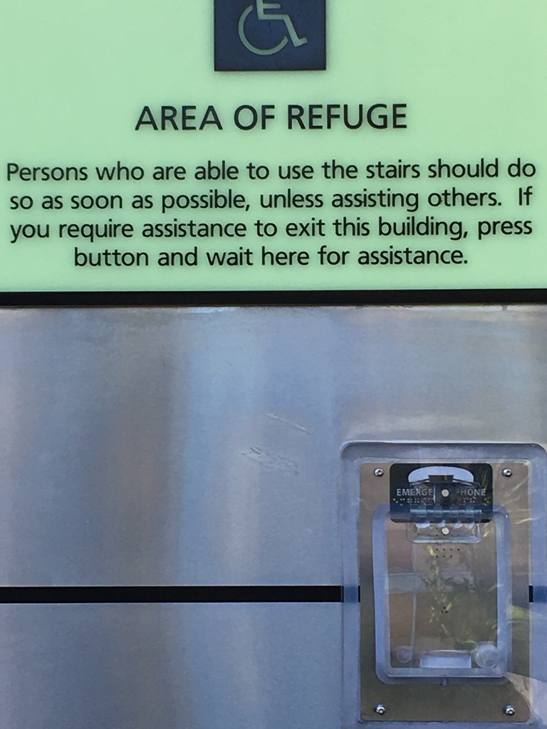 Area of Refuge: Persons who are able to use the stairs should do so as soon as possible, unless assisting others. If you require assistance to exit this building, press button and wait here for assistance.