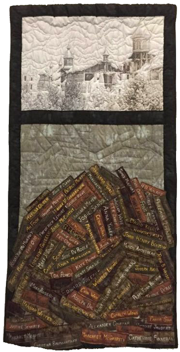 Quilt with an image of a building - below is a stack of books with names