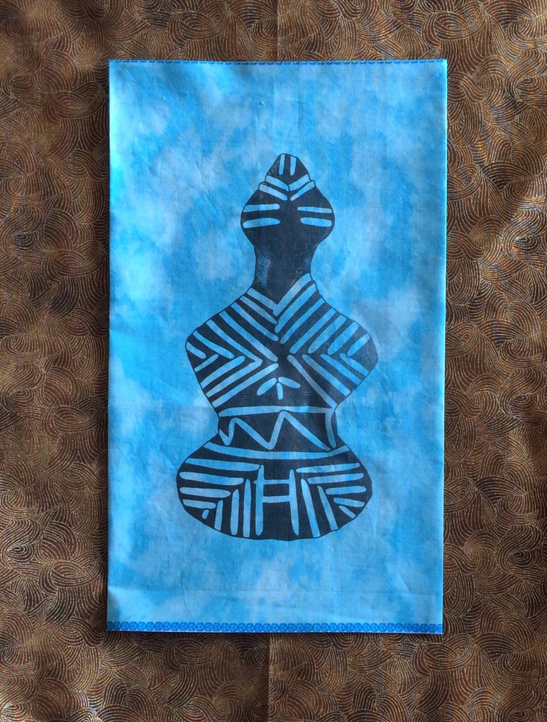 Fabric - outline of a goddess in black against a blue background.