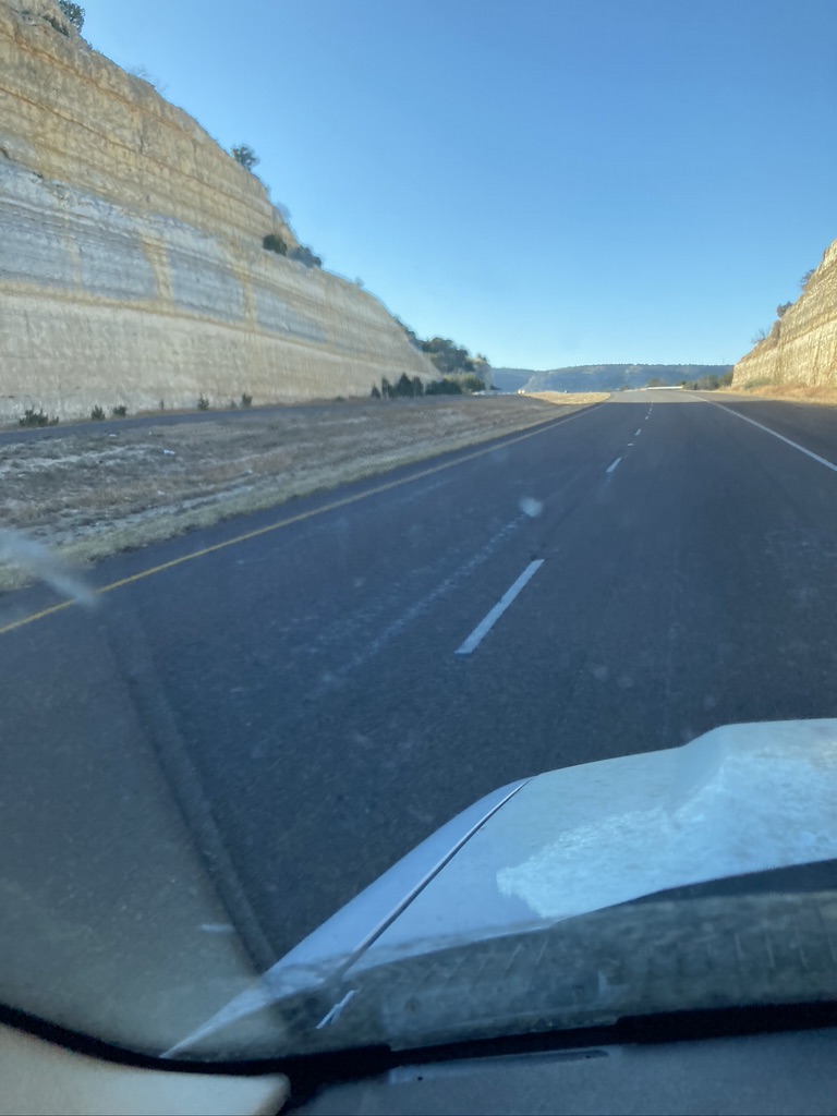 view of highway through a giant split boulder