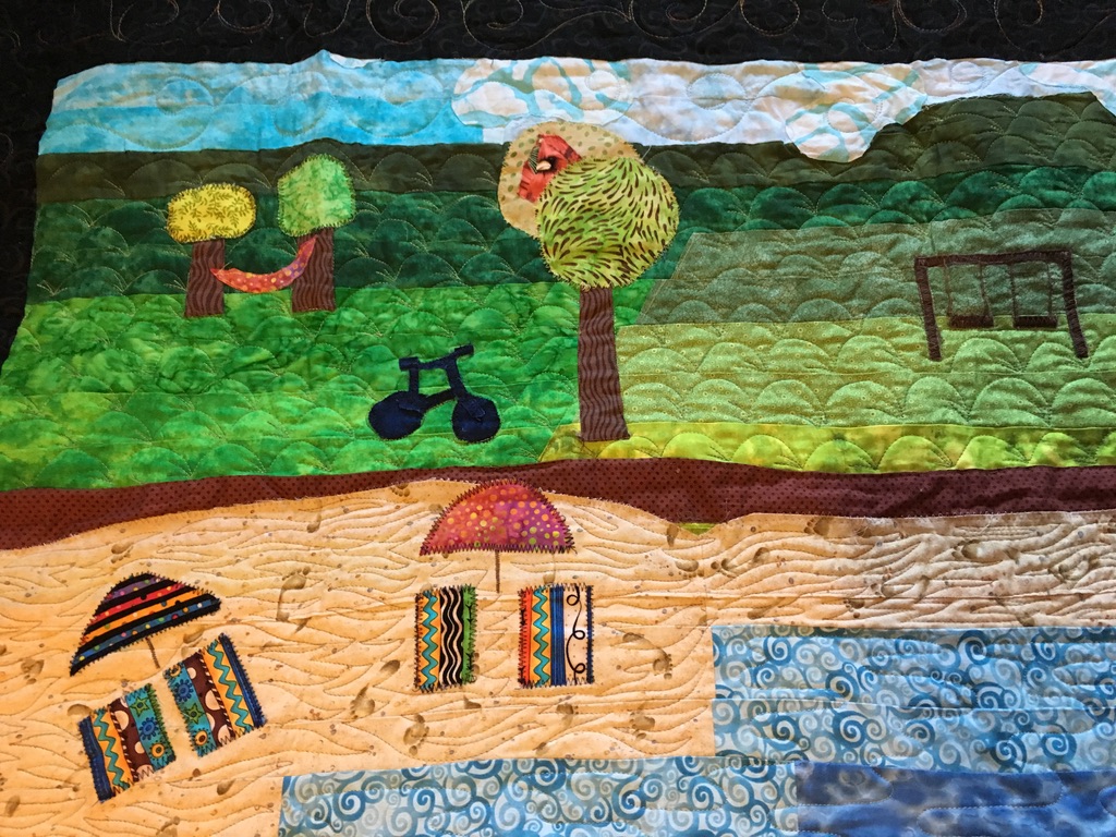 Fabric piece - a beach with an umbrella, tree and bicycle.