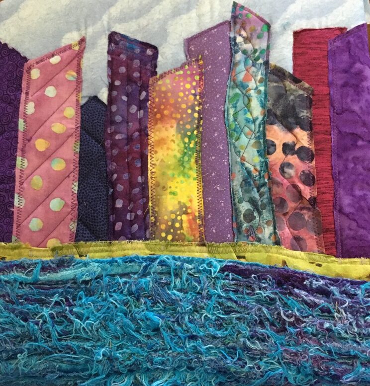 Fabric piece: blue fabric on bottom representing water; buildings above.
