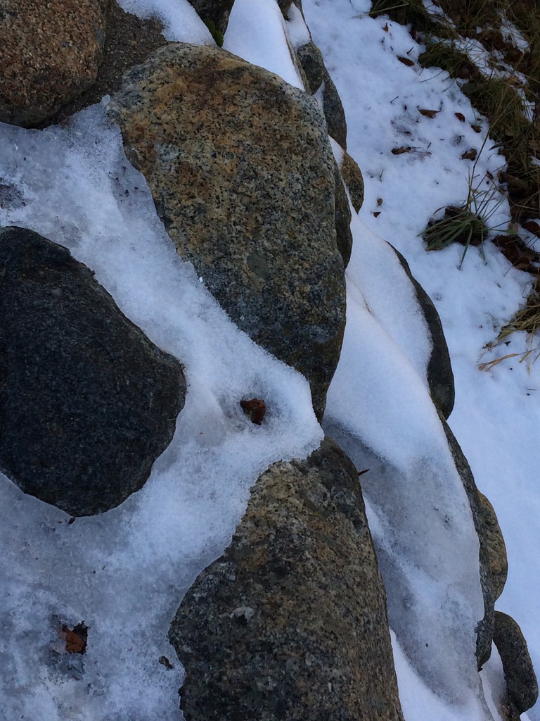 Snow in between granite rocks.