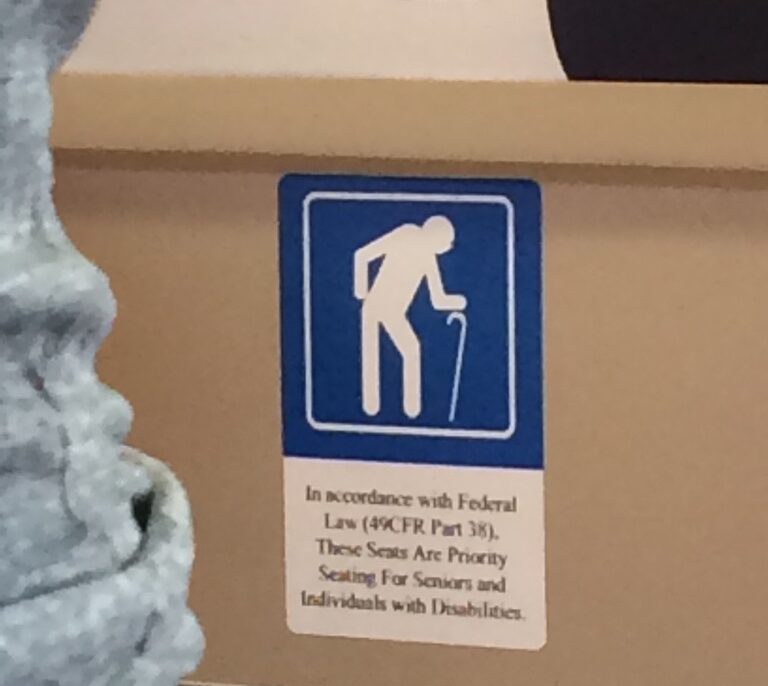 Icon of a man bent over and using a cane, designating seating for older or disabled persons.