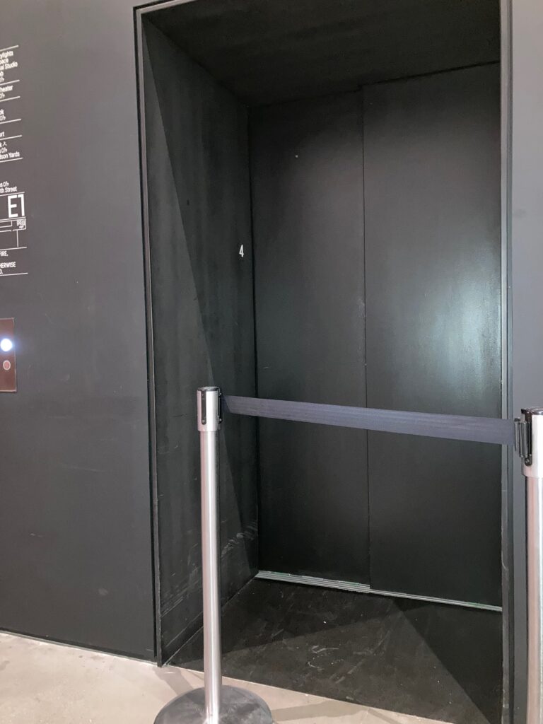 Photo of elevator blocked by poles and webbing